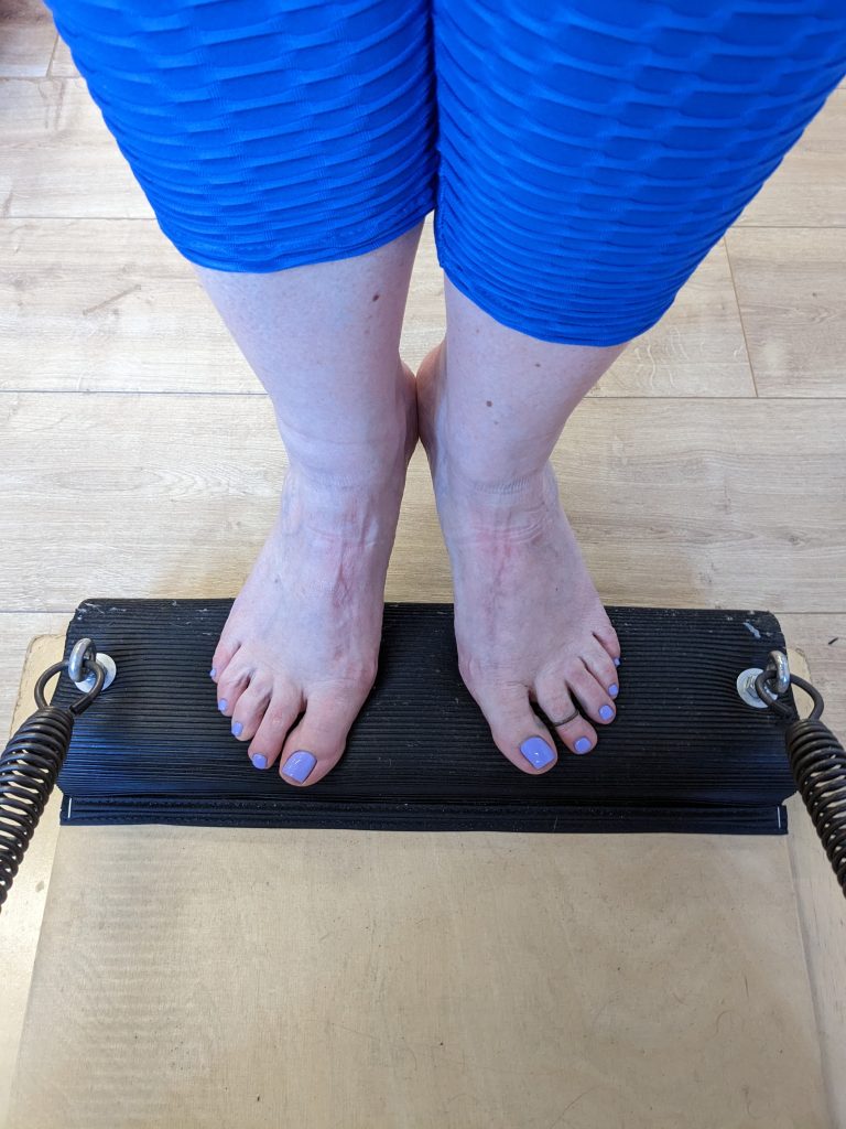 feet on a pilates apparatus
