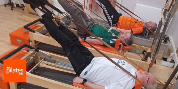 men doing pilates on reformer